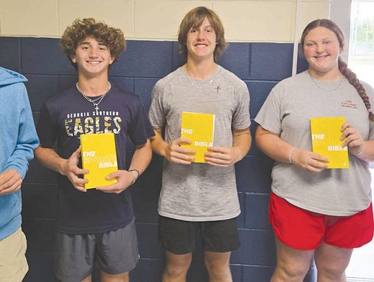 FCA distributes Bibles to eight grade students at BCMS