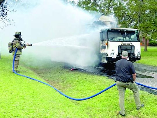 Trash truck catches fire