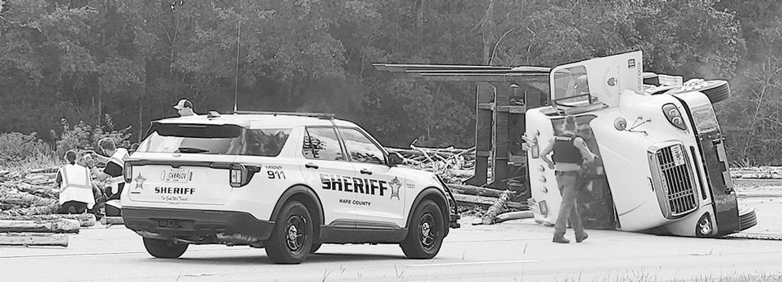 Log truck spill halts Ga. 38 traffic Log truck spill halts Ga. 38 traffic