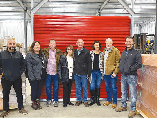 <p>Team pictured in front of RDI’s first door produced with employees’ signatures on the door. The first truck load of doors shipped April 28.</p>