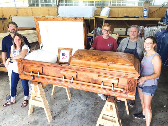 <p>South GA Casket Company employees surround a finished example of their work. (l-r) Owner Jody Gill, Gill’s wife Tracy, Benjamin Crews, David Hicks and Shane Vickery.</p>