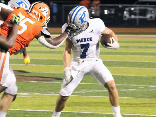 <p>Bear quarterback Caden McGatha (7) is grabbed by the facemask. A penalty flag was thrown on the play giving the Bears an extra 15 yards.</p>