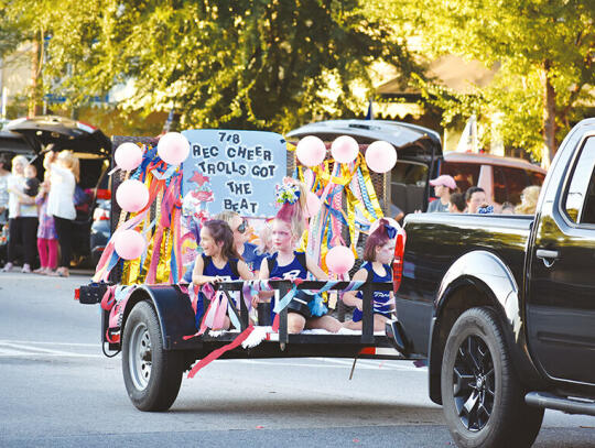 <p>Rec. department cheerleaders smile at the crowd</p>