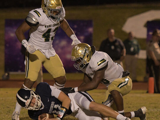 Ware County defenders Isaiah Perry, top left, and Trey Hargrove team up for a second quarter sack on Statesboro High quarterback Bruce Yawn on Friday, Oct. 28. (Statesboro Herald photo/Scott Bryant)