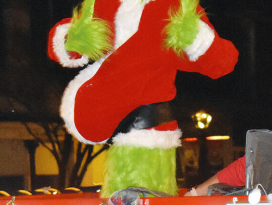 <p>The Grinch shows a rare burst of positivity riding on the float for Down to Earth Trailers.</p>