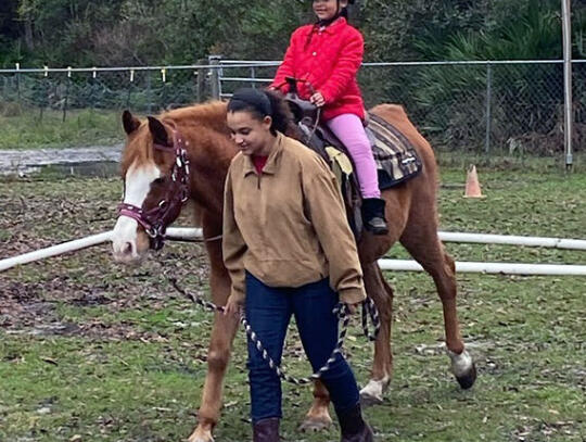 Hooves to Freedom also has specific activities for at risk youth, victims of trauma, abuse and grief. Student rider Lexlie Boardes participates in equine therapy with the horse led by Lili Boardes.