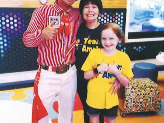 Amris extreme bull jam2: Local Rodeo Clown Colt 45 (Colt Hartt) of Patterson (left) is shown with Amris Bedford (right) and Amris’ grandmother, ‘Jam’, Pam Walker. Bedford battled cancer at St. Jude until she passed away in 2021 at the age of 10.