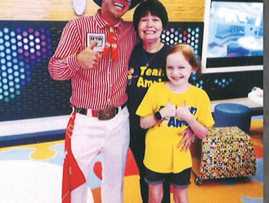 Local Rodeo Clown Colt 45 (Colt Hartt) of Patterson (left) is shown with Amris Bedford (right) and Amris’ grandmother, “Jam”, Pam Walker. Bedford battled cancer at St. Jude until she passed away in 2021 at the age of 10.