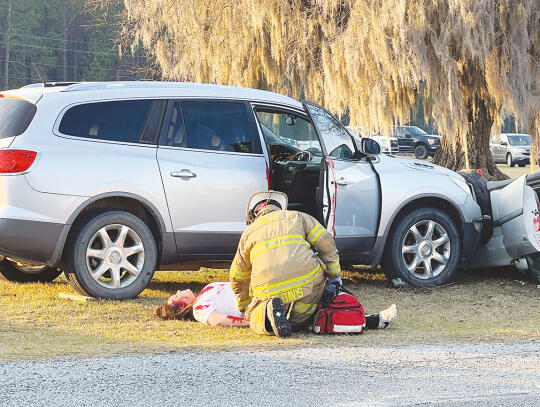 Blackshear Firefighter Leon Davis treats “Samantha” (Gracee Goddard) at the crash scene.