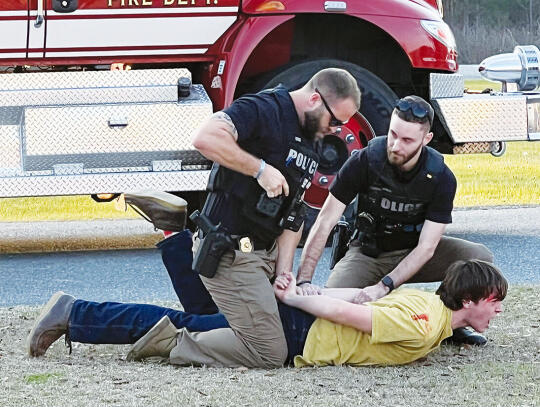 Blackshear Police Officers Jacob Royal (left) and Ashton Thomas arrest “David” (Christopher Kuhbander) who caused three fatalities in the car accident because he was driving under the influence of alcohol.