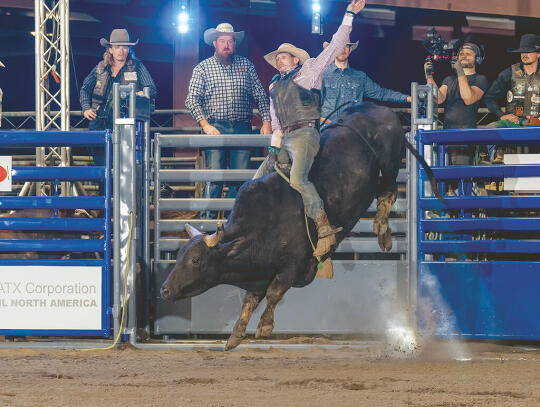 Bull Rider Kevin “Rooster” McKeeman of Celina, TN, rides a bull during the rodeo.