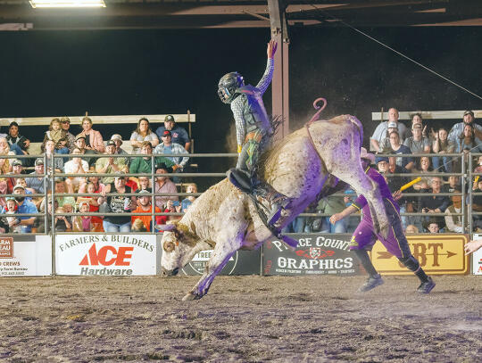 Junior Bull Rider Cole McGriff, 11, of Waycross, rides a bull during the rodeo.