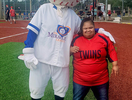 Pinky Solomon poses with “Homer”, the mascot of the Miracle League.