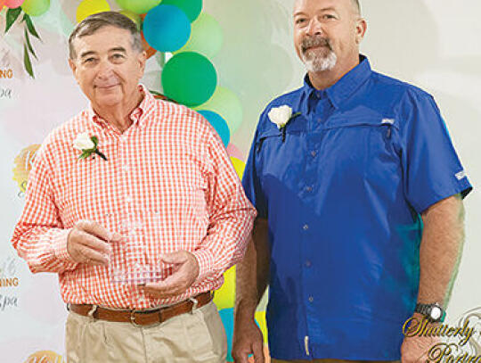 Orin Bennett (left) and Phil Bennett (right) receive the Farmers of the Year award.