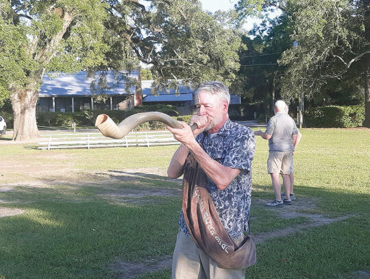 Dr. Earl Martin commences the prayer meeting with a resounding blast from his ram’s horn trumpet, also known as a shofar.