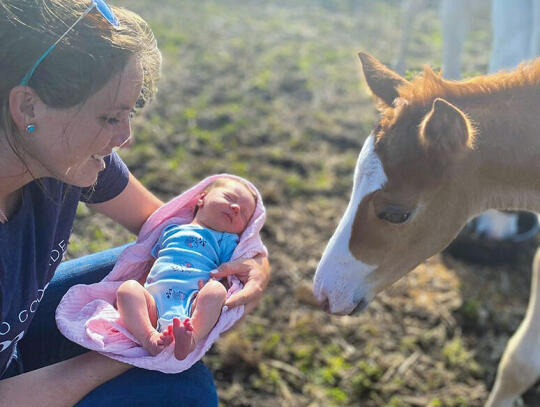 Merrill Hodges introduces her newborn daughter Harper to the foal Sharpie. Harper Hodges and Sharpie share a birthday.