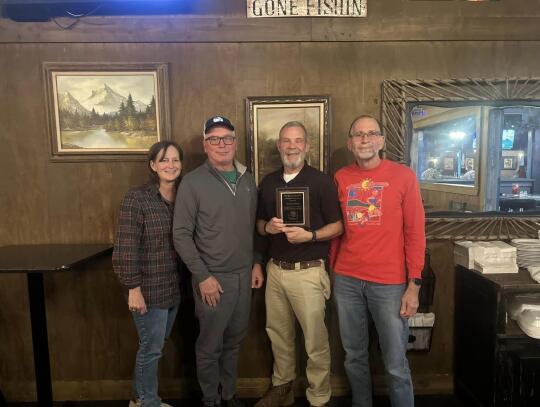 The Okefenokee Track and Cycling Club presented the 2024 Ron Crosby Distinguished Service Award to David Moore for his years of service as President of the Club and also as a coach to the local youth cross-country teams. Pictured are fellow Club members Jennifer Smith, Orrie McCrea, David...